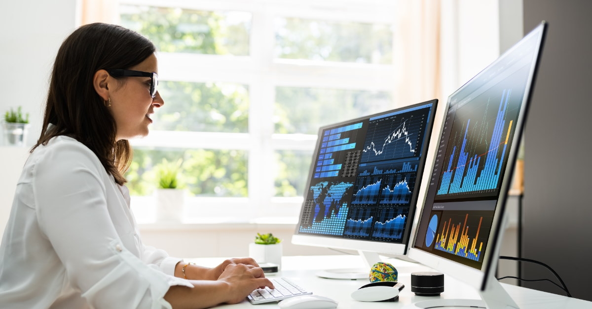 female data analyst using computer to upload data at work