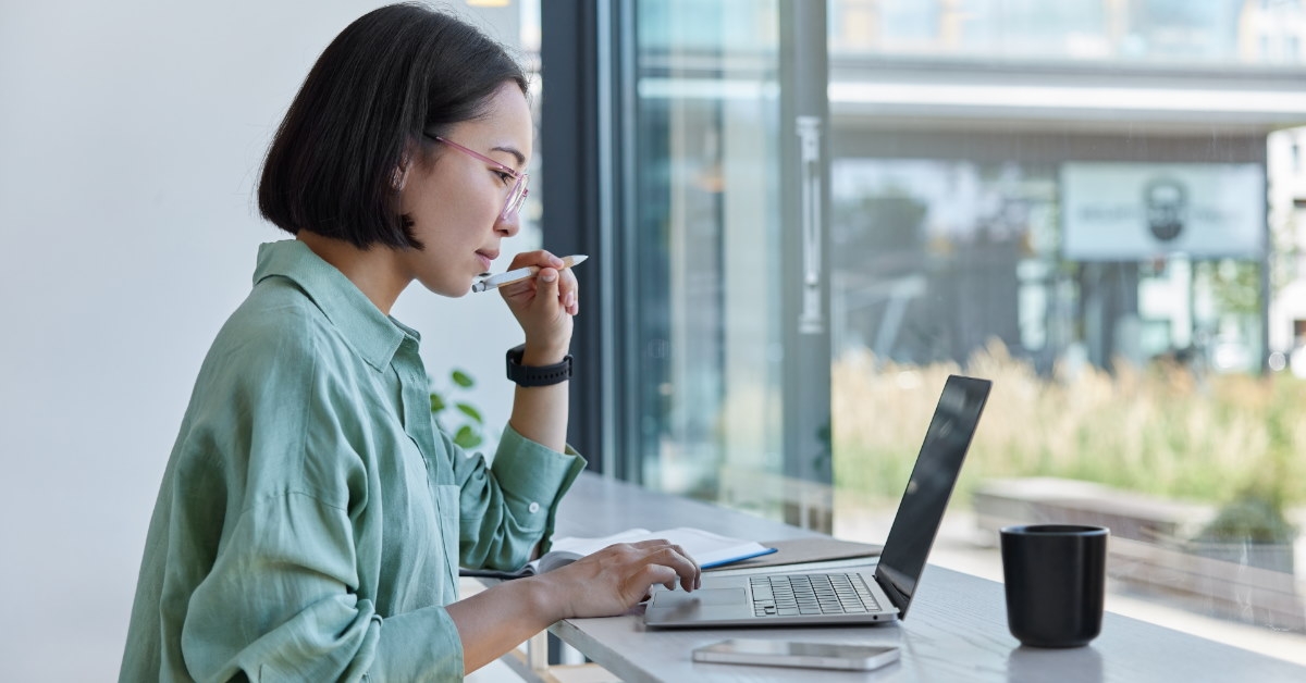 asian woman studying on laptop 