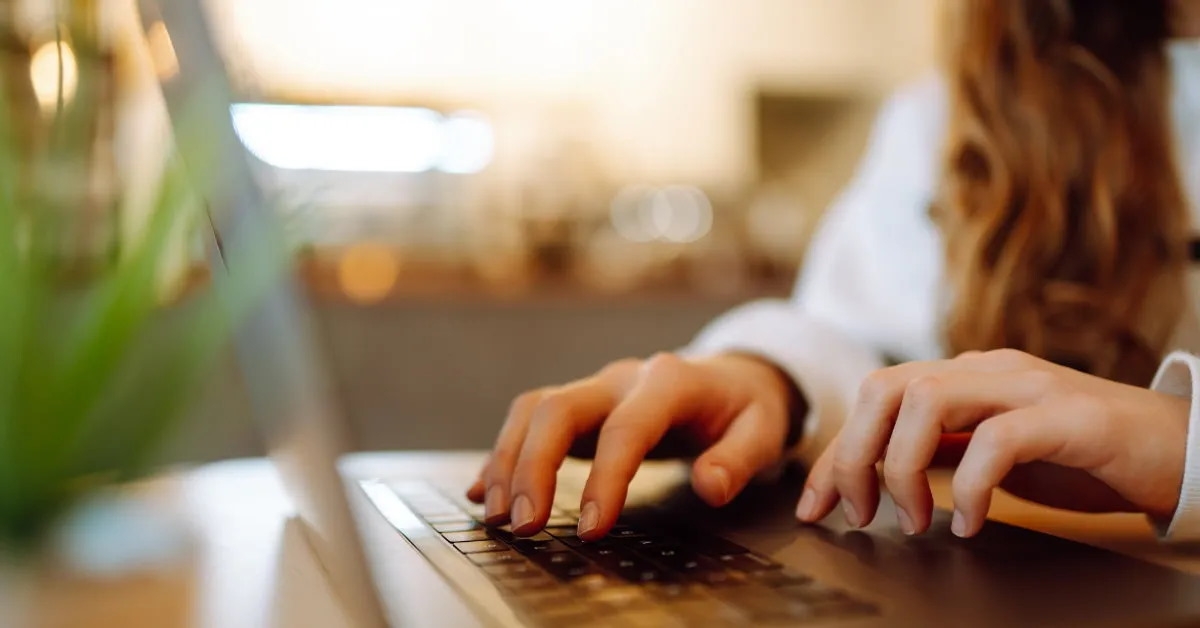 woman typing on laptop 