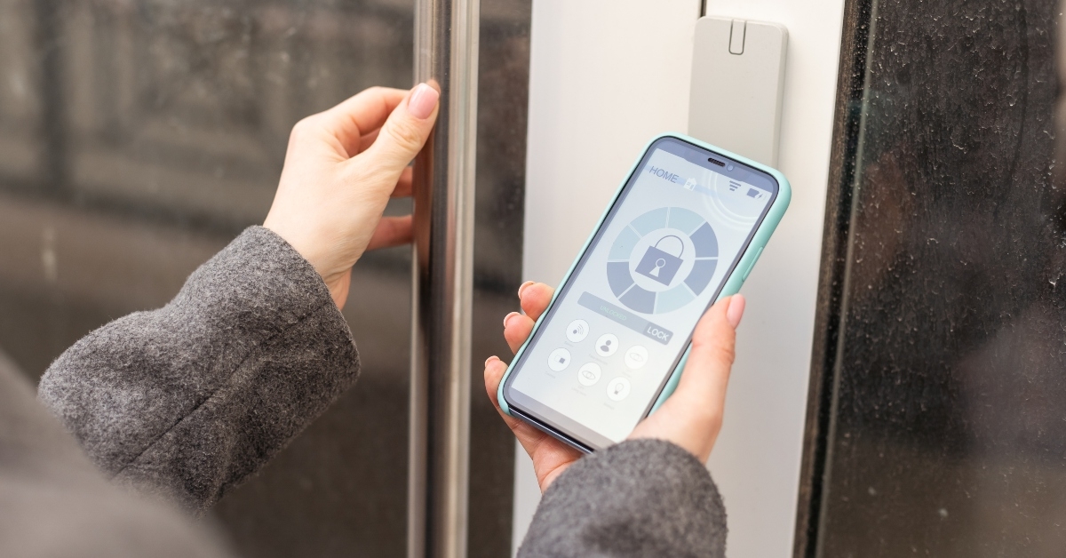 woman locking smartlock on the entrance door