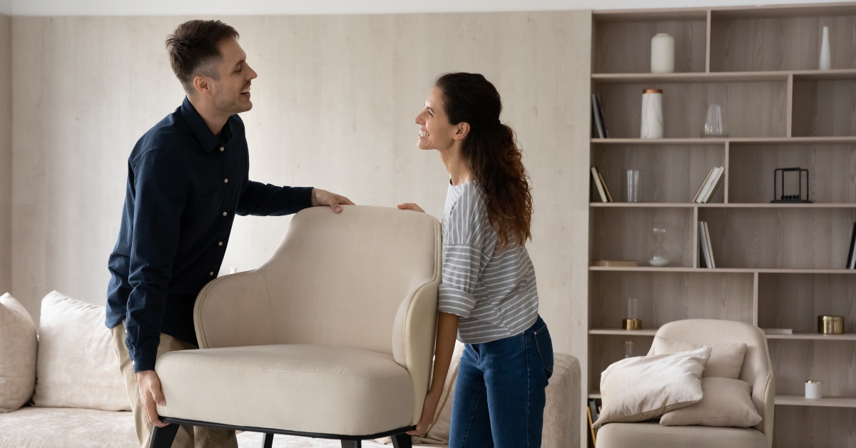 couple homeowners holding armchair
