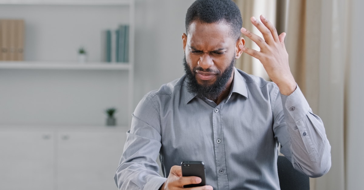 angry african american man angry using smartphone