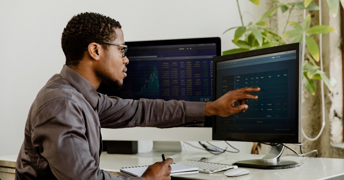 businessman using desktop computer to analyze data