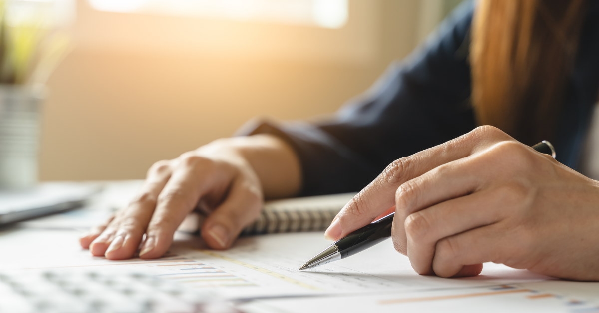 businesswoman using pen to finance budget