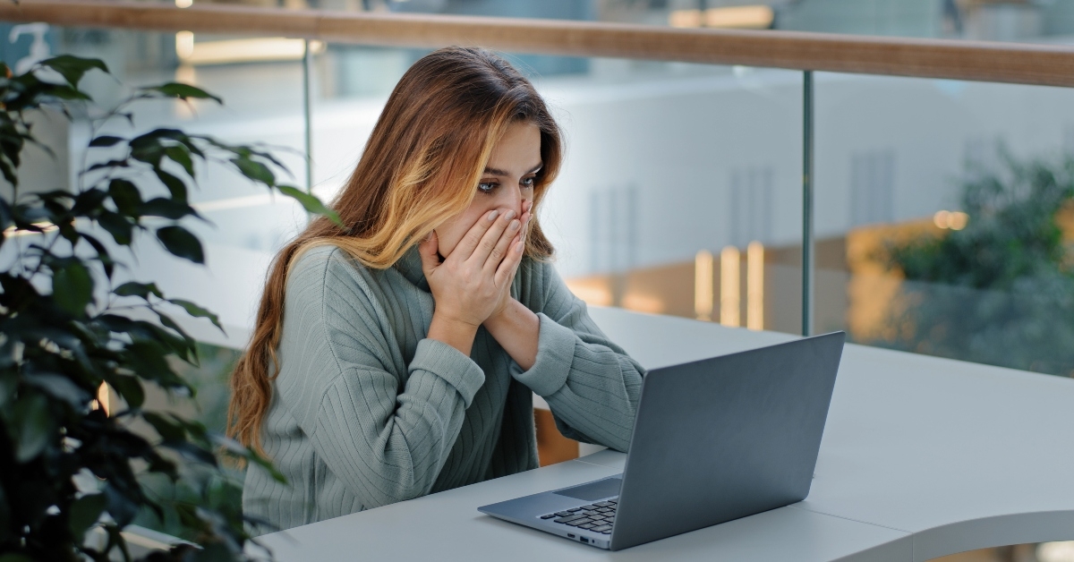 businesswoman with laptop getting frustrated