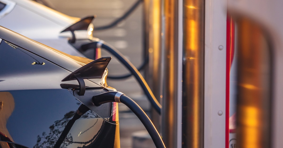 electric cars in que getting charged at charging station 