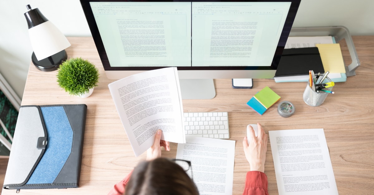 female translator working on papers using computer