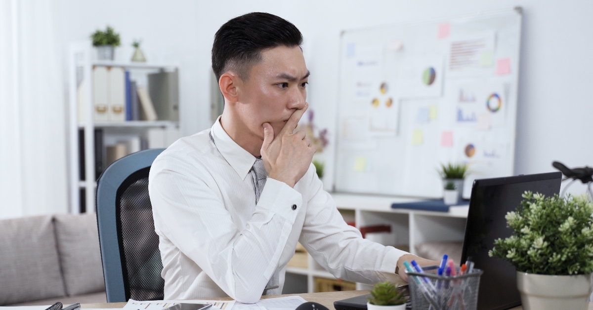 male worker writing email on notebook