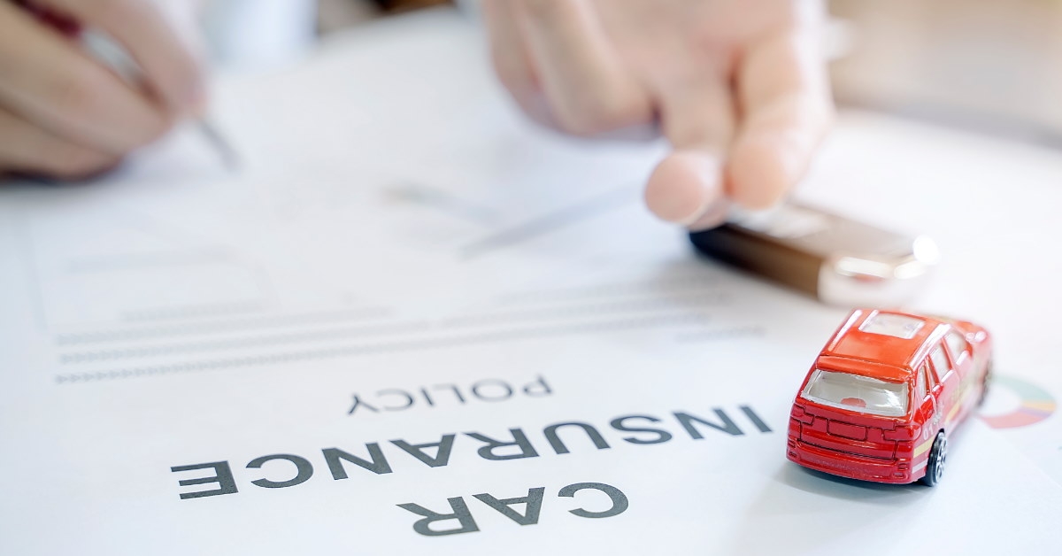 man signing car insurance policy 