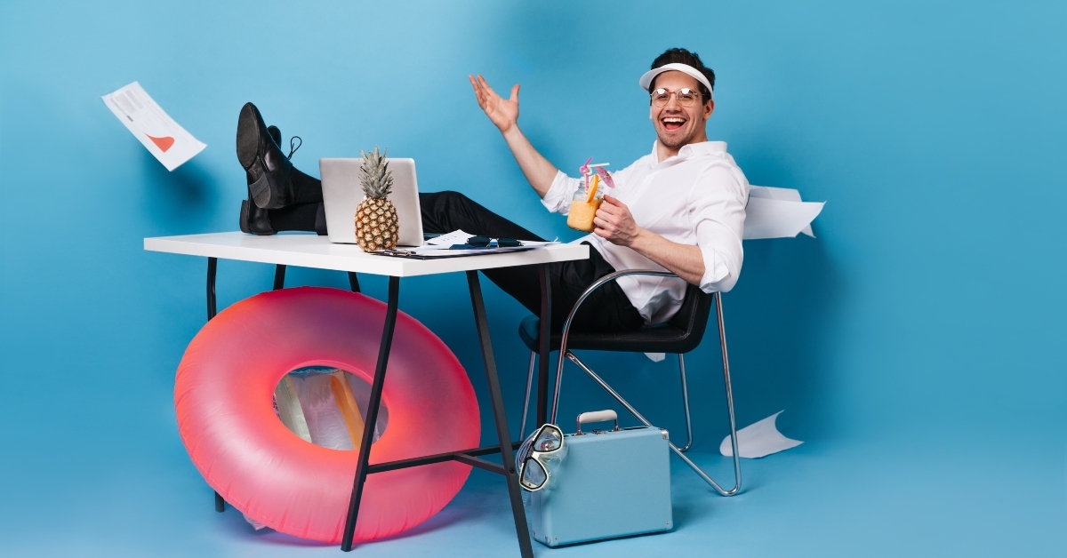 perky businessman in suit and cap scatters graphics