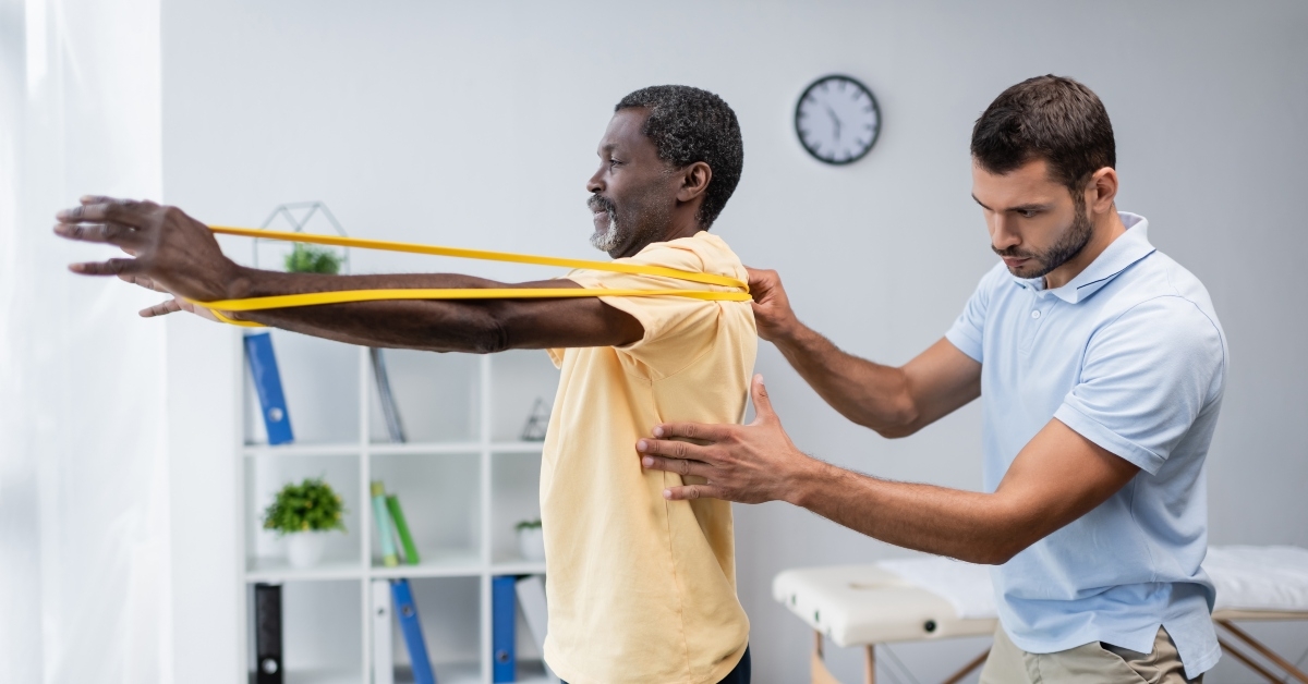 physical therapist assisting man training