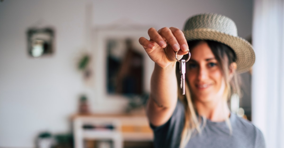 beautiful woman holding keys of new apartment