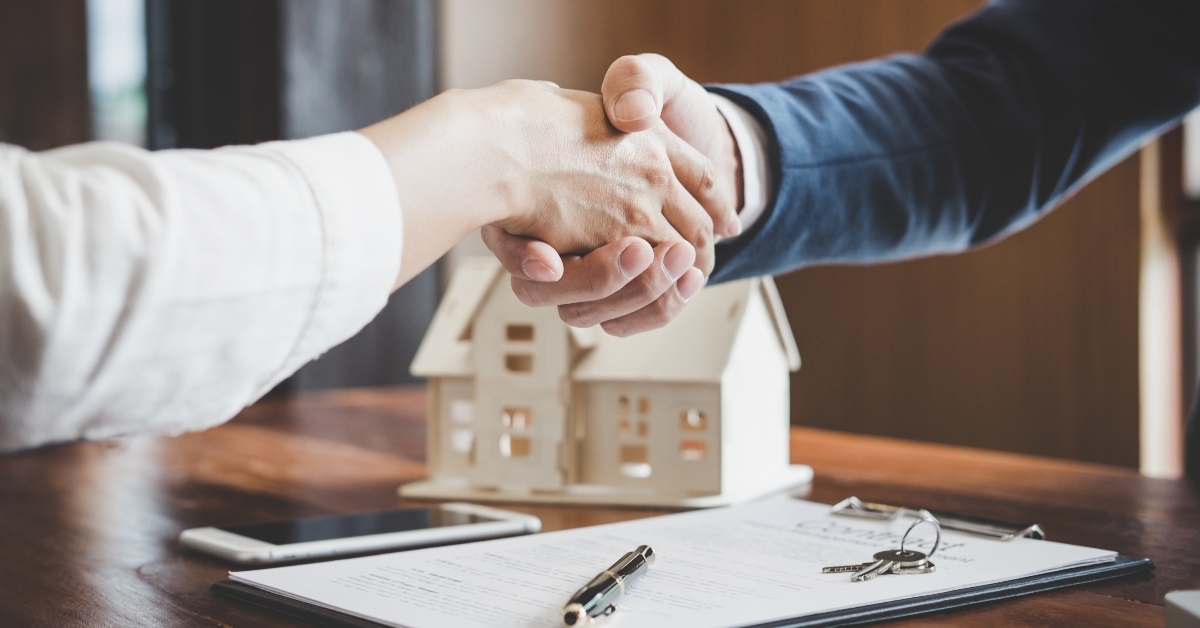 estate agent and customer shaking hands 
