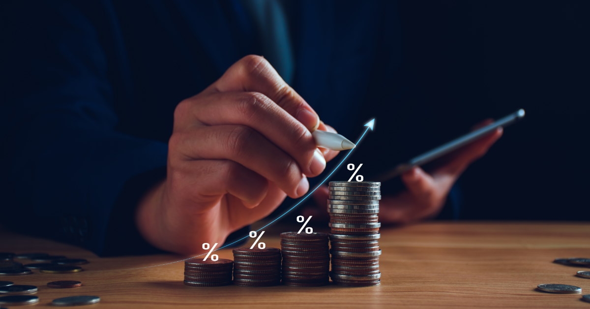 businessman sitting at table with stack of pennies using 3d pen 