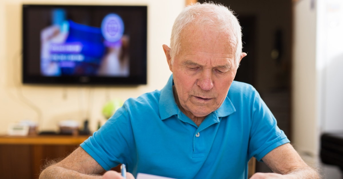 senior man sittingre reviewing forms