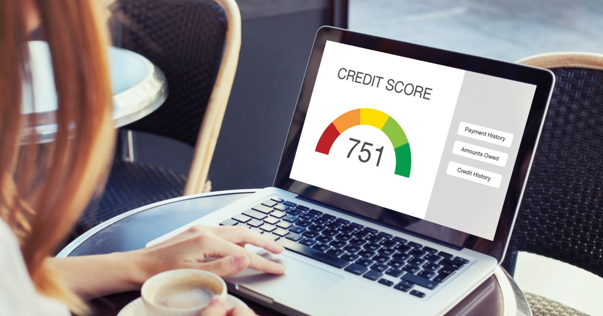 woman using laptop showing credit score 751 