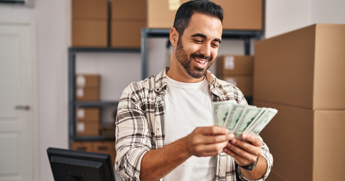 ecommerce business worker counting dollars 