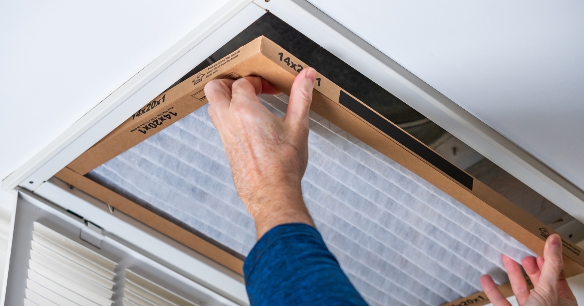 man replacing dirty HVAC air filter