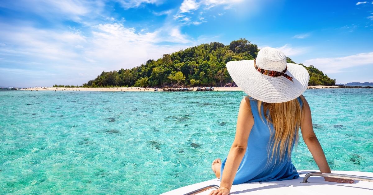 tourist woman with sunhat sits on a yacht