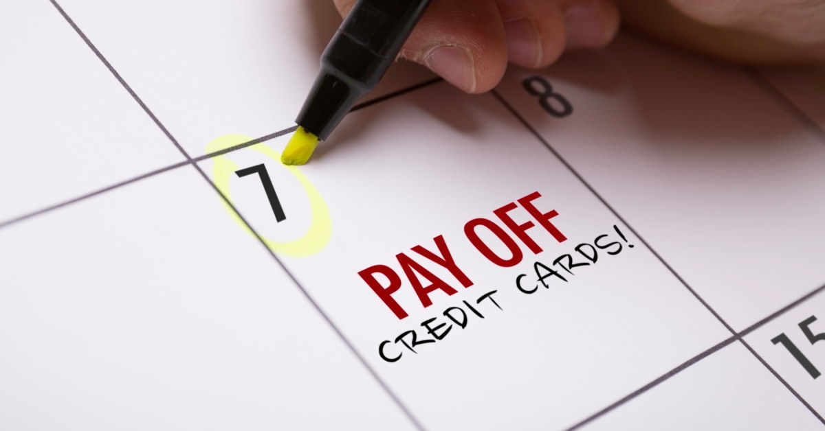 man using yellow highlighter to remind himself about paying off credit card debt 