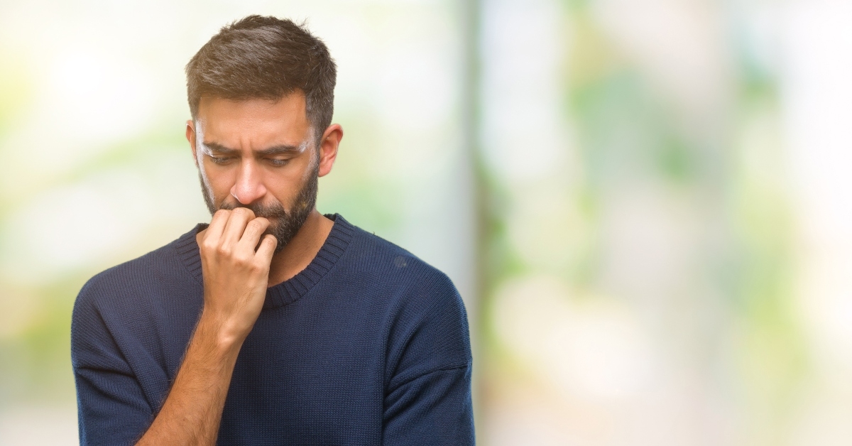 man looking stressed and nervous with hands