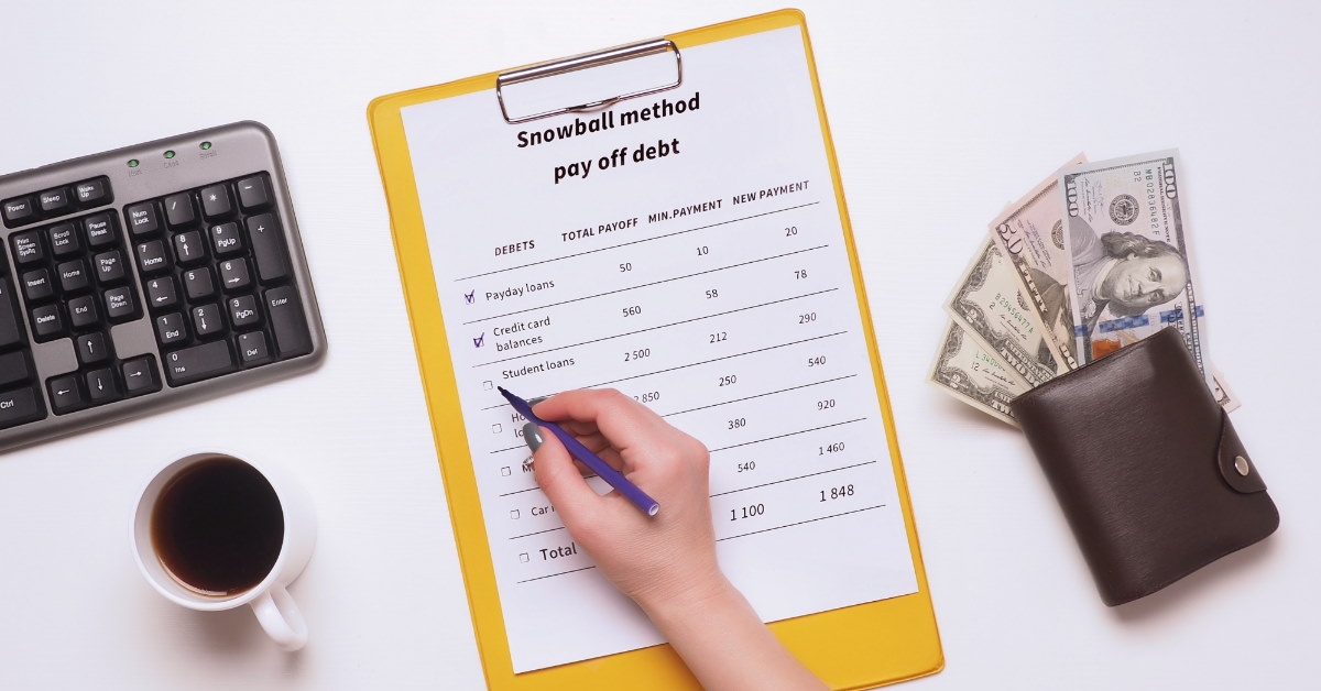 woman using pen to fill snowball method pay off debt form 