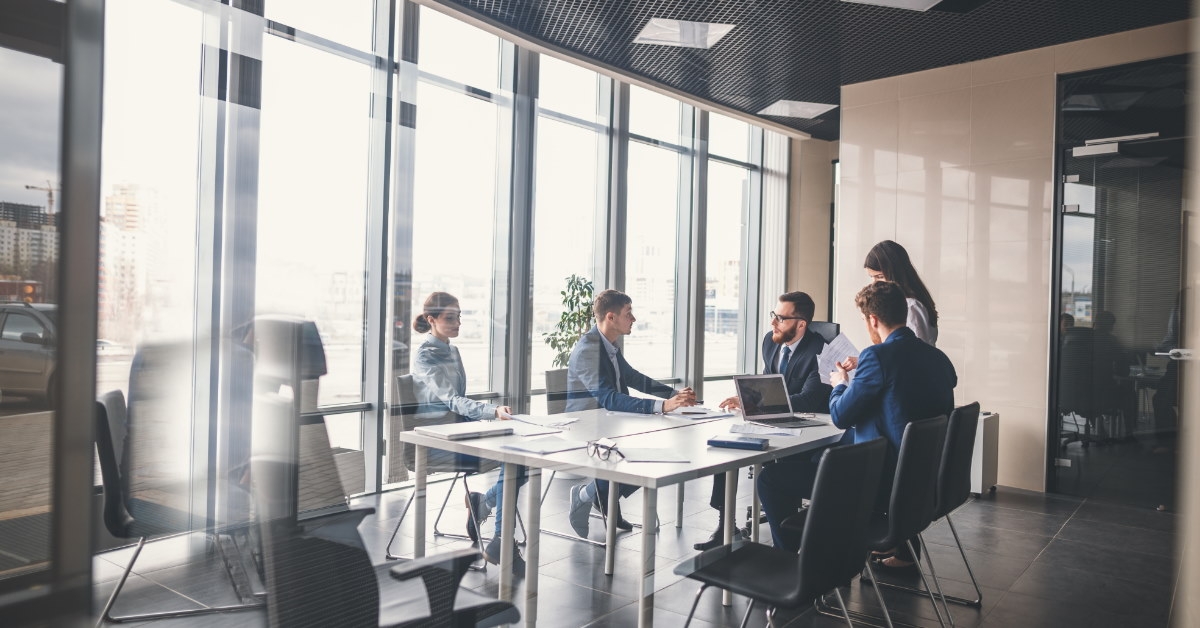 team discussing ideas in conference room while sitting at table
