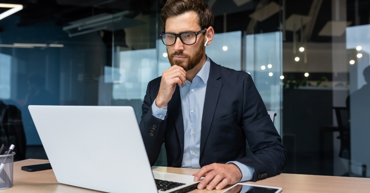 businessman wearing suit doing work on laptop  in office