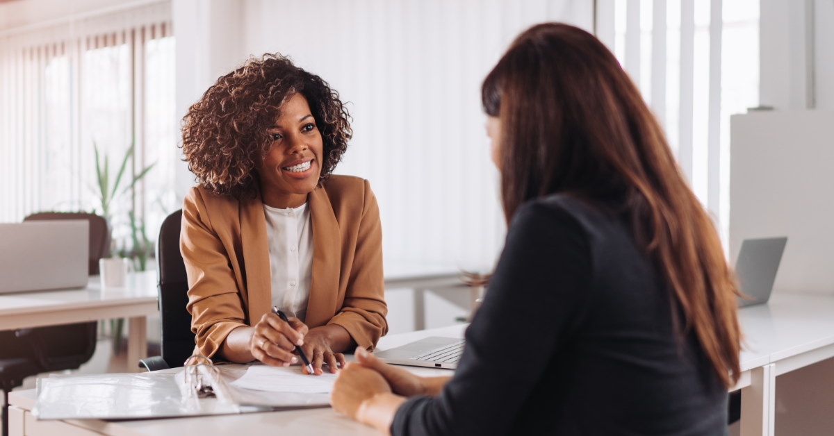female finance advisor explaining policies to female client in office