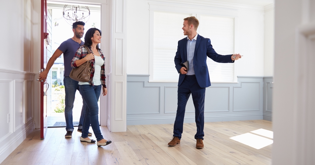 realtor showing couple around new home