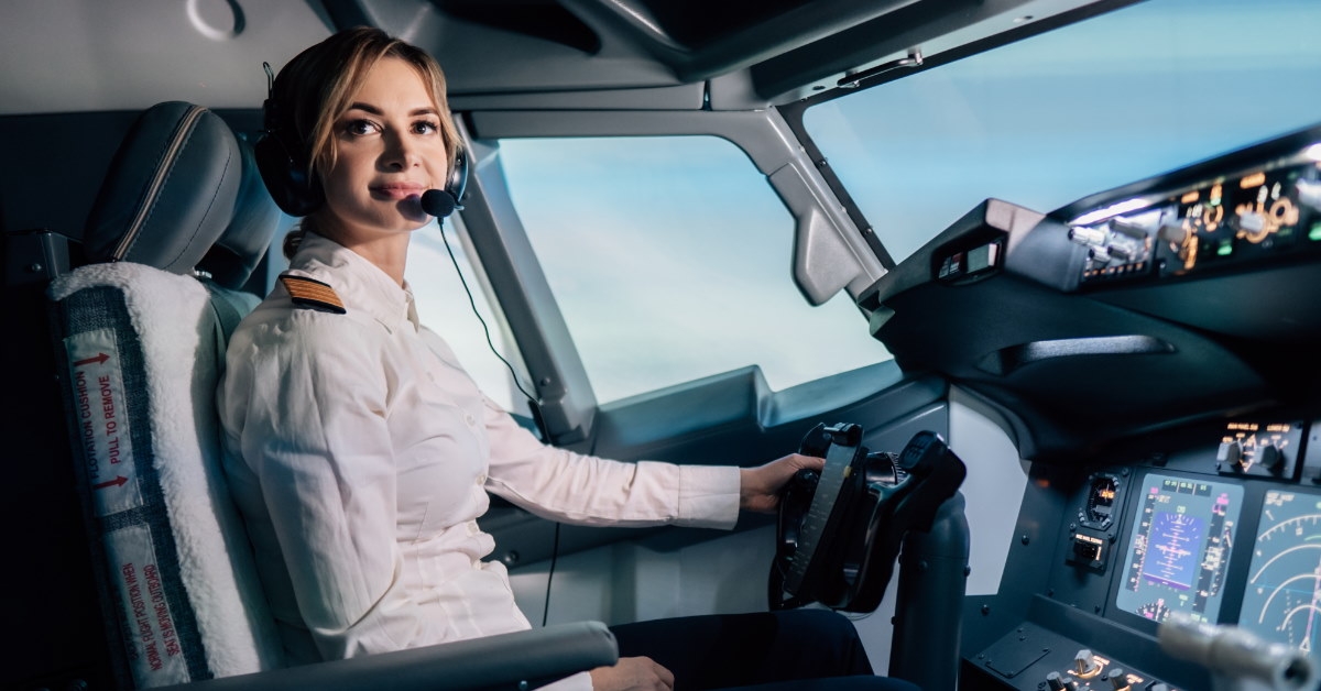 woman pilot sitting in cockpit flying aeroplane