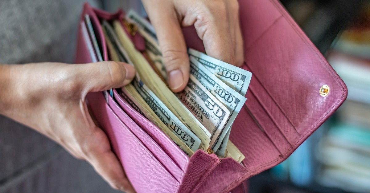 woman taking out us dollar