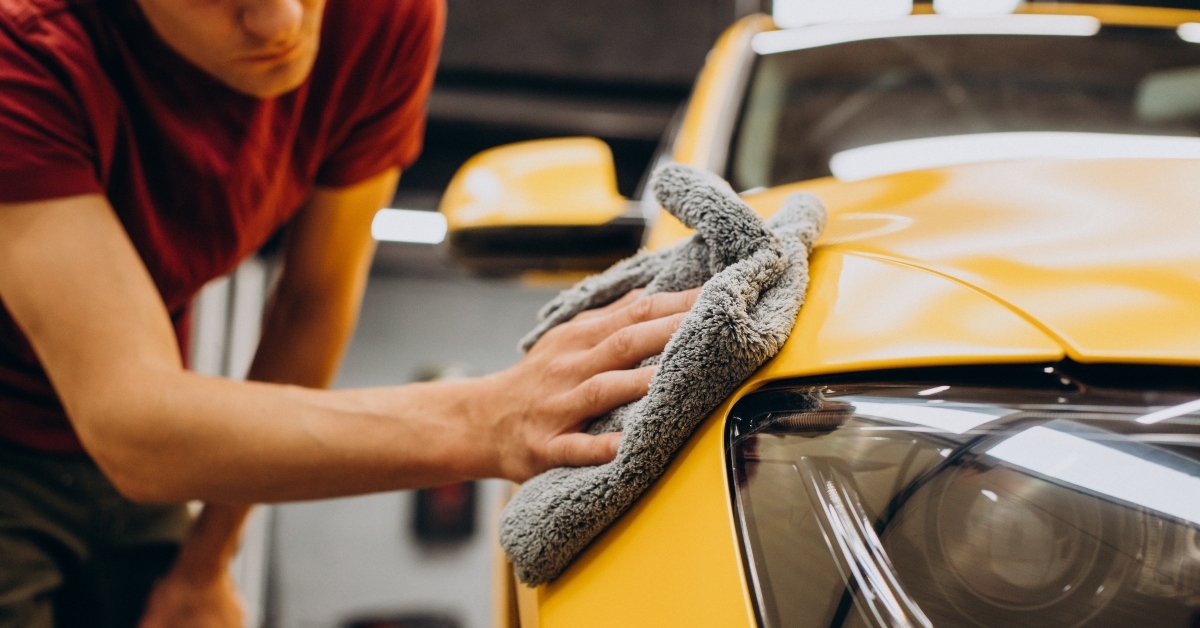 man wiping car with microfiber after wash