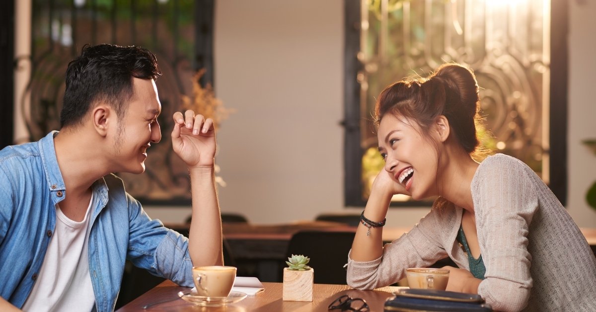 asian couple enjoying date in cafe