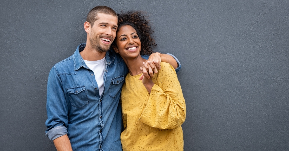 multiethnic couple in love standing and holding hands