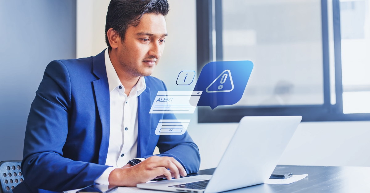 businessman sitting at table using laptop for work