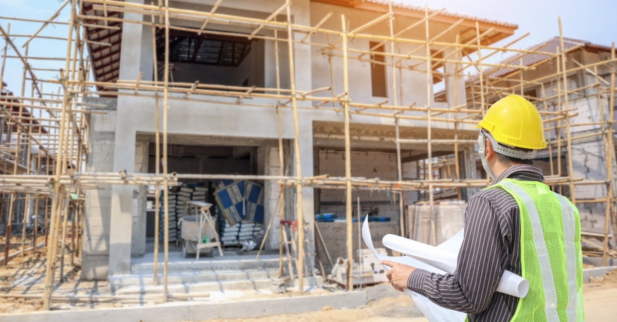 engineer with protective helmet and blueprints papere