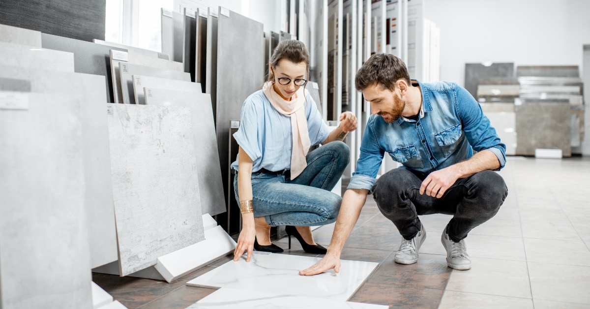 young couple choosing big granite tiles