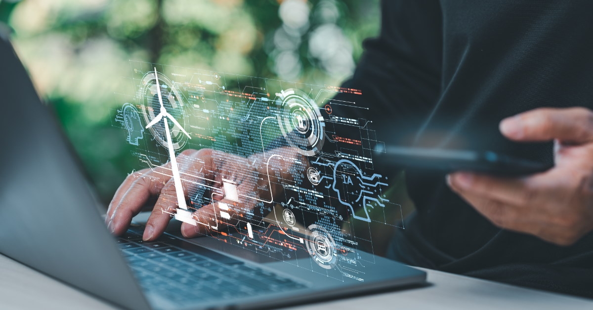 man using laptop for coding using smartphone
