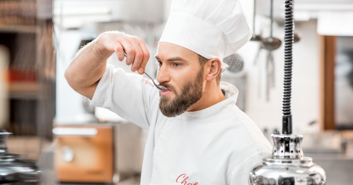chef tasting with spoon the food at the restaurant