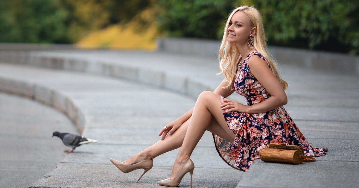 girl with perfect legs sitting at the city square
