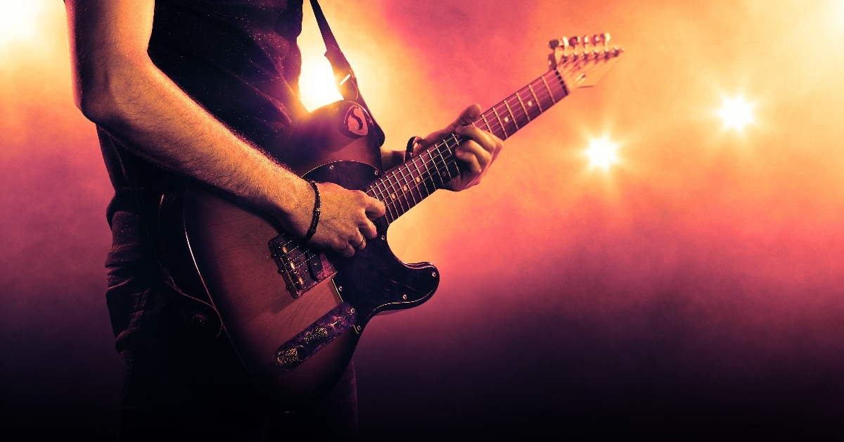 hand of a guitar player playing a guitar