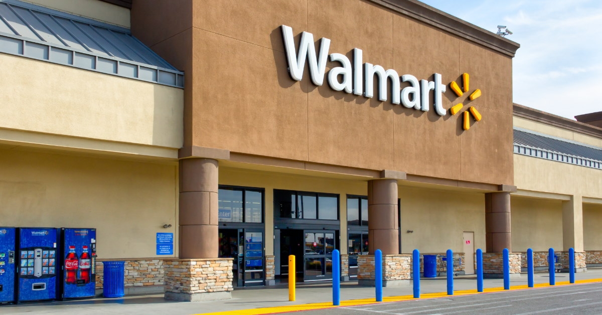 Huge Walmart sign board outside store during day time with wending machines