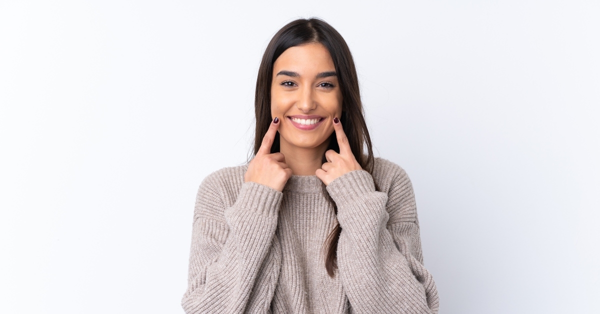 woman over isolated white background smiling
