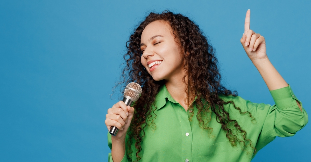 woman singing song in microphone