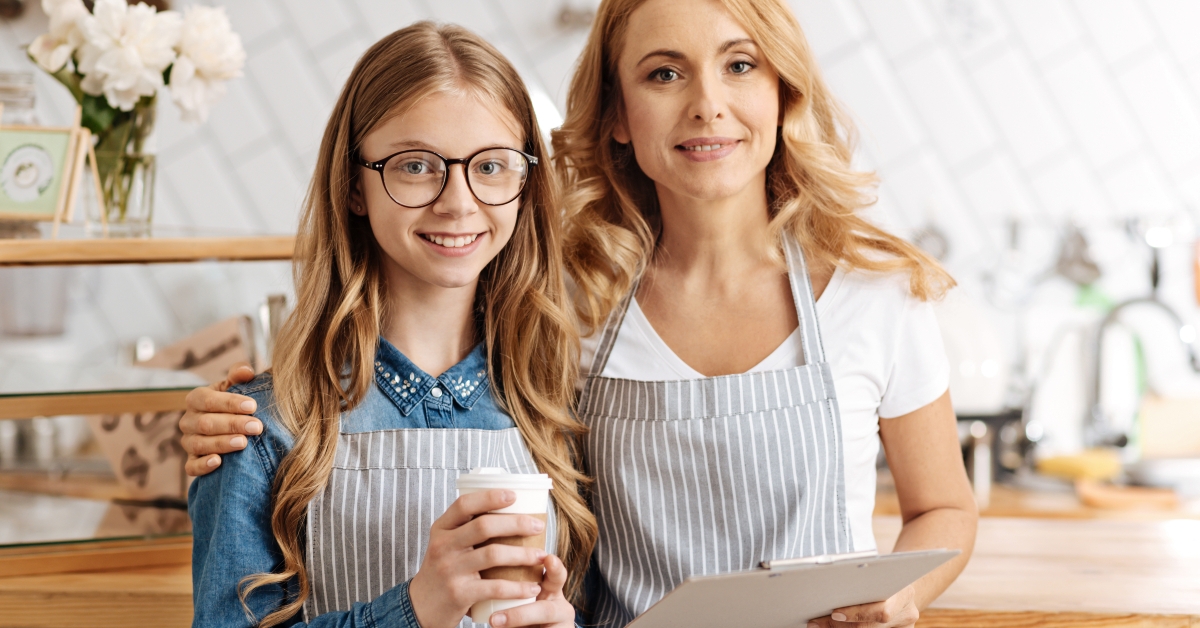 mother hugging her daughter and posing for the camera