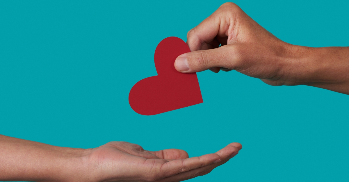 person giving a heart to another person 