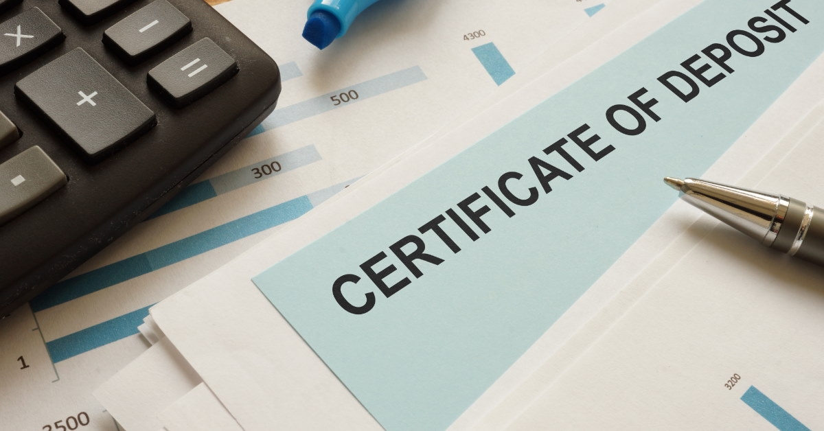 certificate of deposit placed at table with pen calculator and highlighter