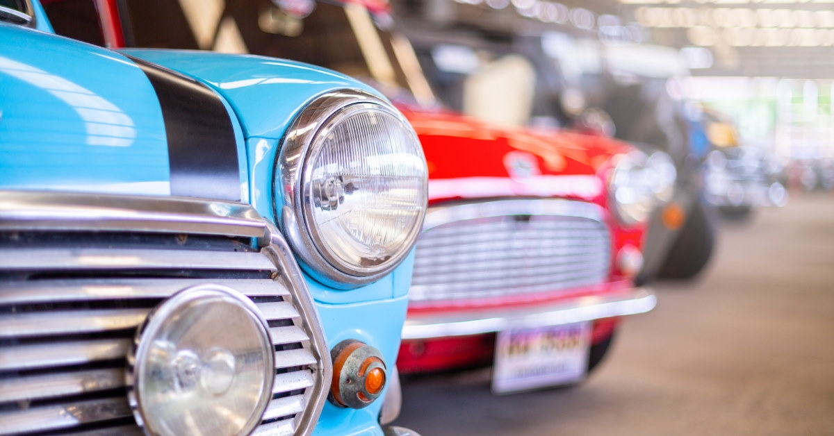 closeup of colorful vintage cars lined up in garage