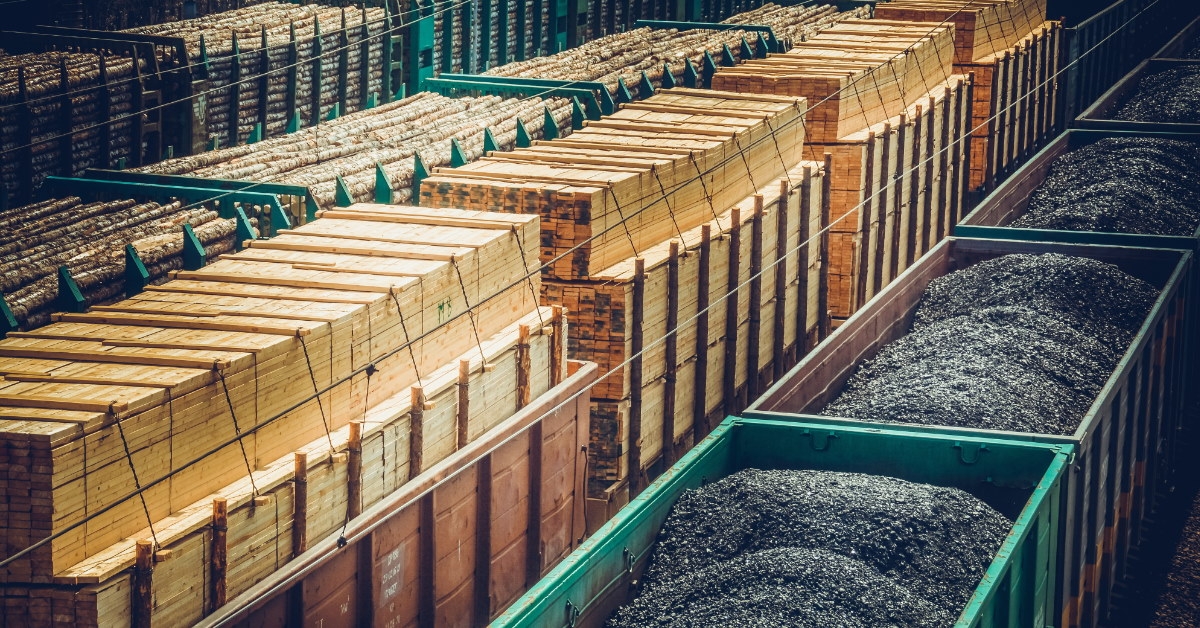 wood and coal filled in containers placed at rail station for transportation